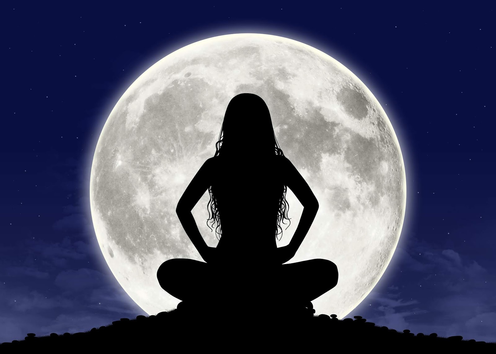 silhouette of a young beautiful woman with long hair in meditation posture with the full moon on the background